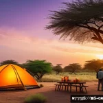 Home 19 차드에서 텐트 캠핑하기 - A panoramic campsite scene near Lake Chad at sunset, featuring a sturdy wind-resistant tent pitched ...